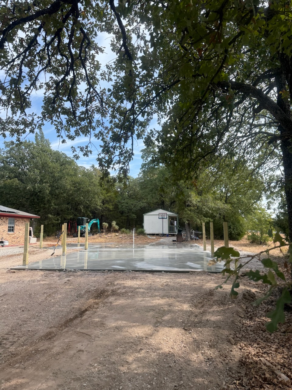 New concrete slab surrounded by mature trees