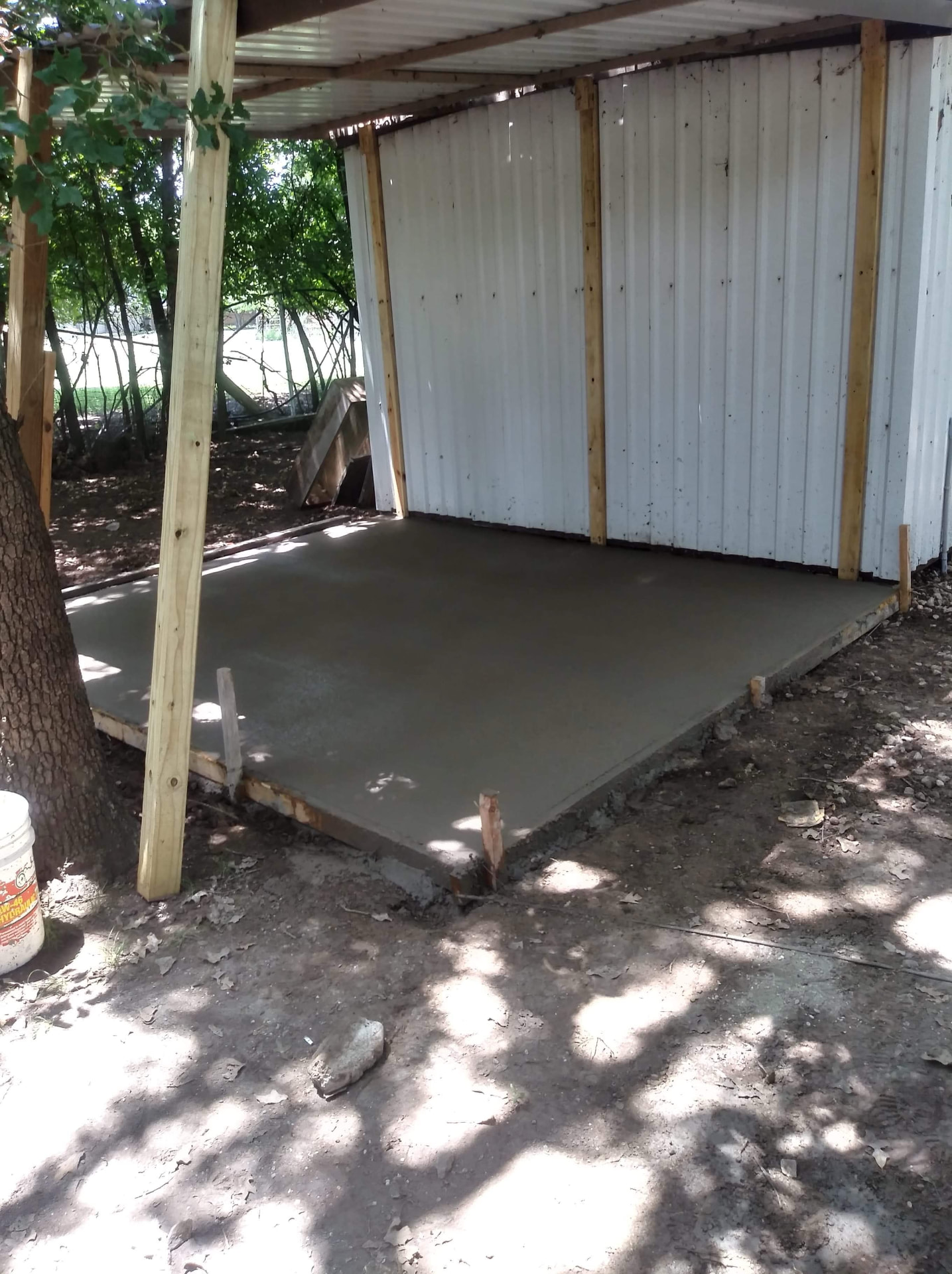 Fresh concrete pad beneath a covered structure